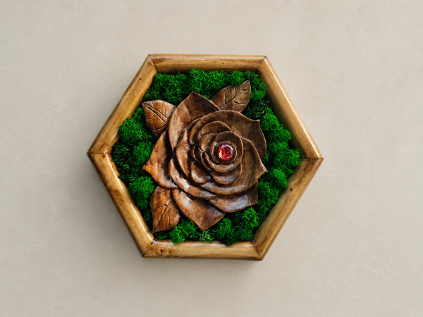 Front view of Mini Botanical Rose, a hand-carved walnut flower with preserved moss, a red glass cabochon and a pine hexagonal frame.