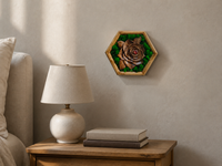 Mini Botanical Rose displayed at its compact scale on a warm plaster wall above a bedside table with a ceramic lamp and books.