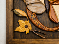 Detailed view of layered wooden botanical elements, natural grain and hand-finished relief surrounding the butterfly.