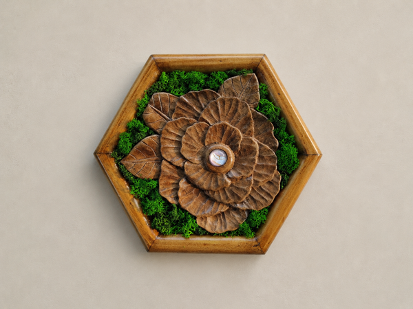 Front view of Mini Botanical Camellia, a hand-carved walnut flower with preserved moss, a pale glass cabochon and a pine hexagonal frame.