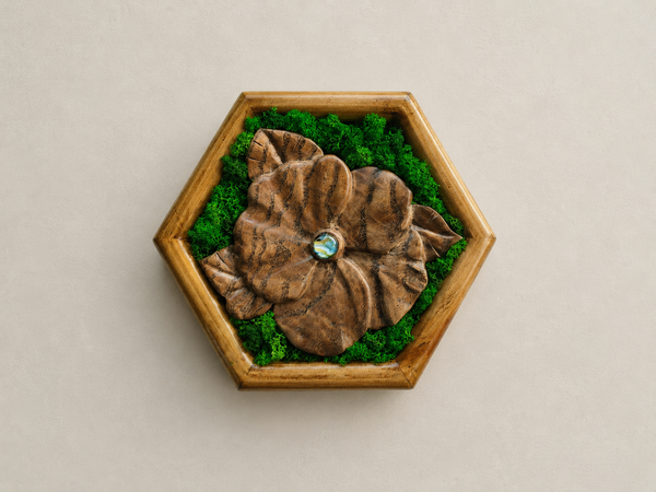 Front view of Mini Botanical Violet, a hand-carved Japanese acacia flower with preserved moss, a blue-green glass cabochon and a pine frame.